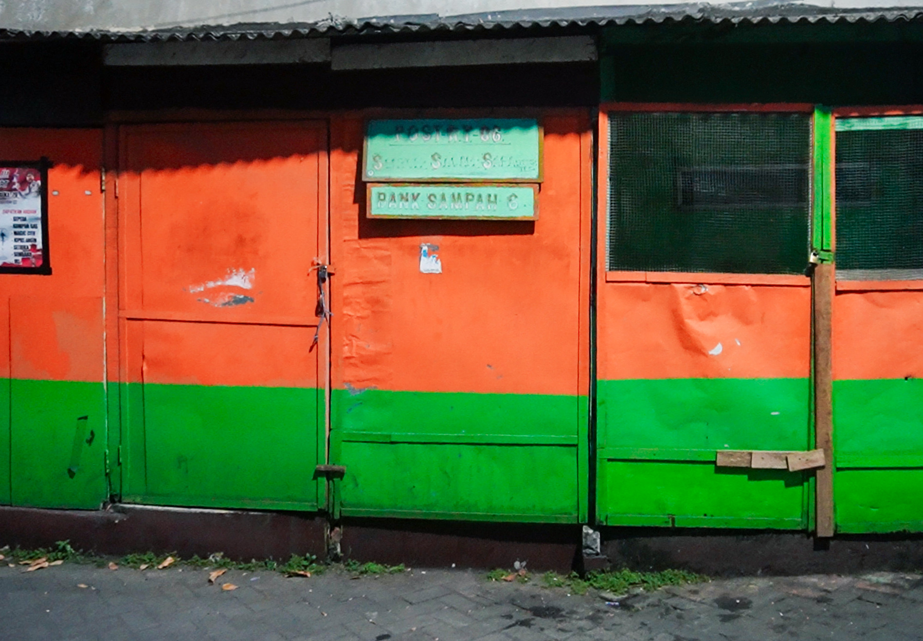 Orange and green building with small window