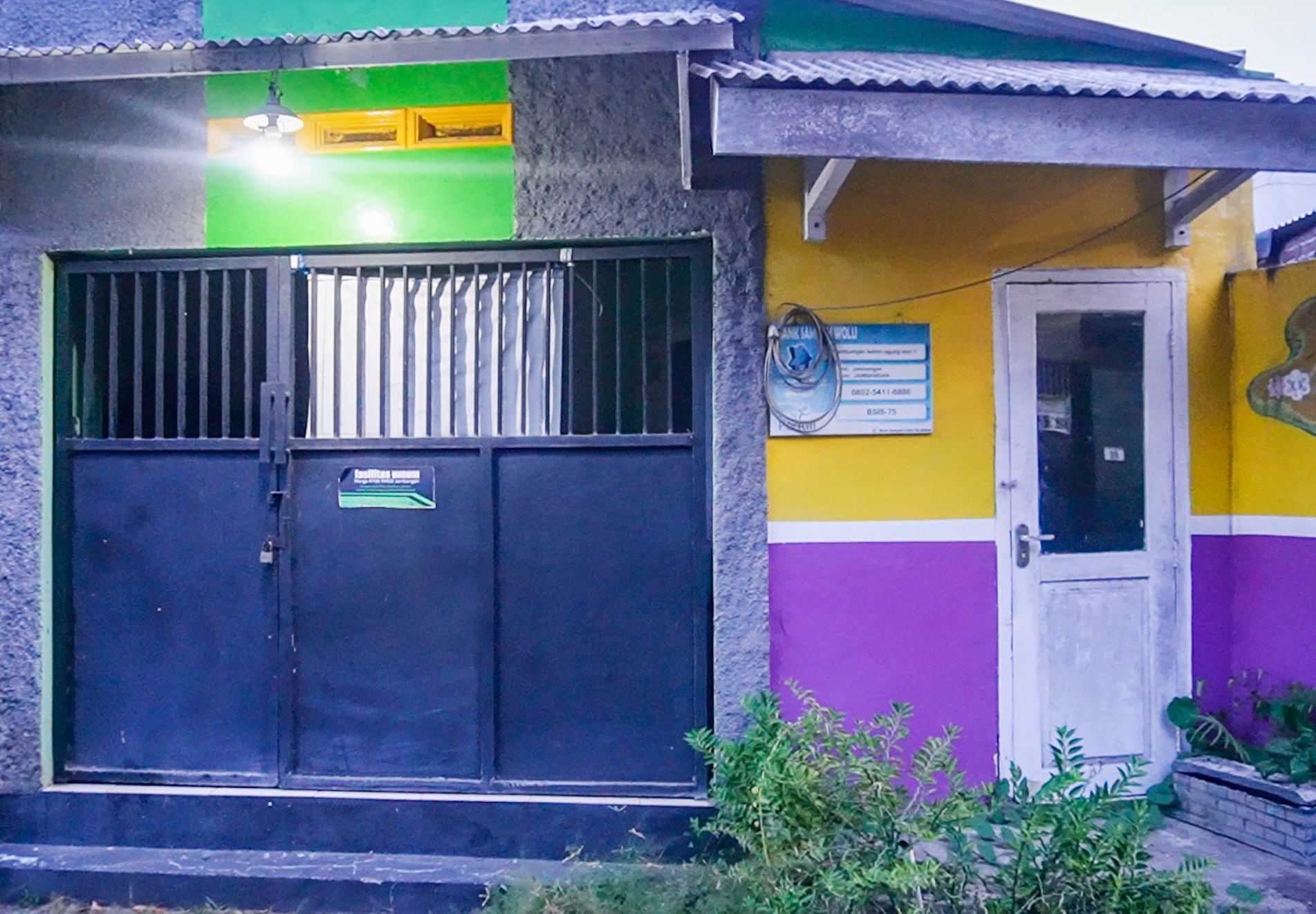 Blue and yellow building with door and window